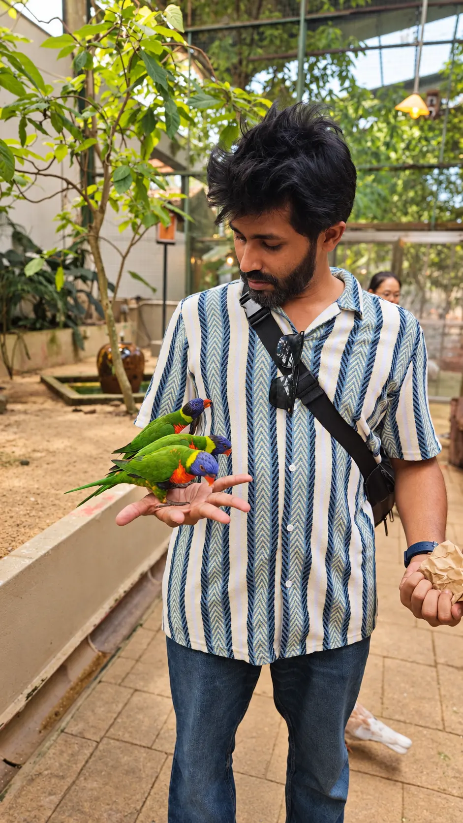 Terry feeding colourful birds in a garden